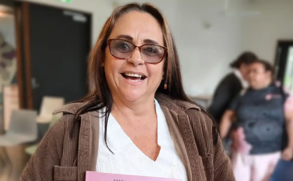 Her Futures Tania-wellbeing - Tania is pictured with a book donated by Stef